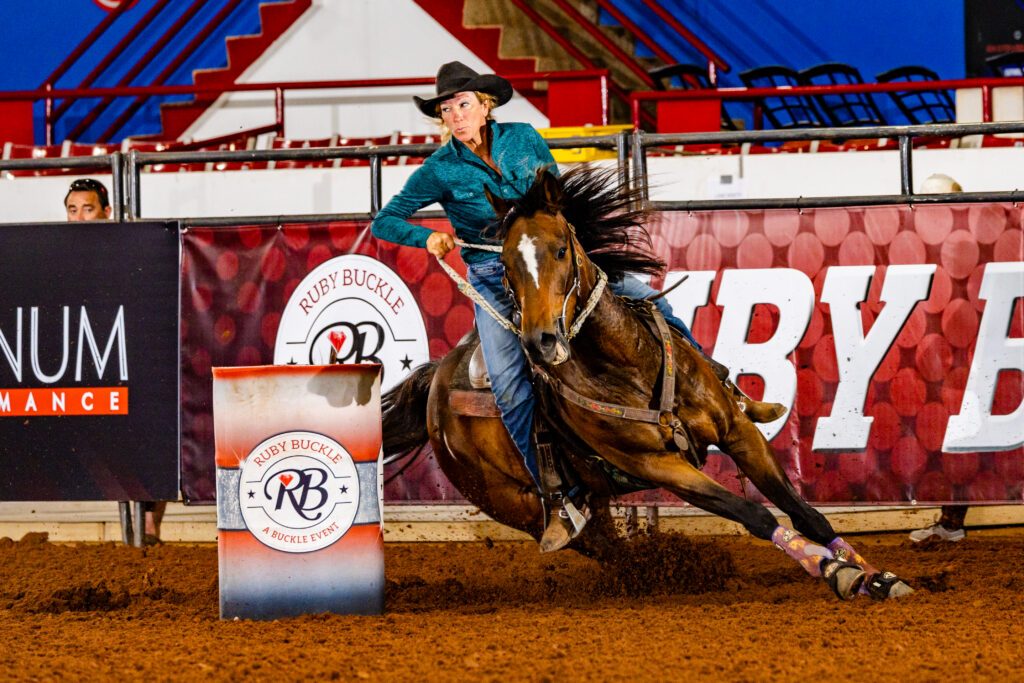 Shari Taggert turns a barrel with her horse's mane flying