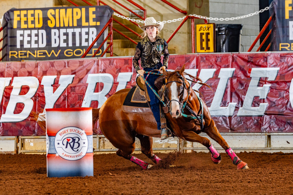 Athlete riding a horse around a barrel