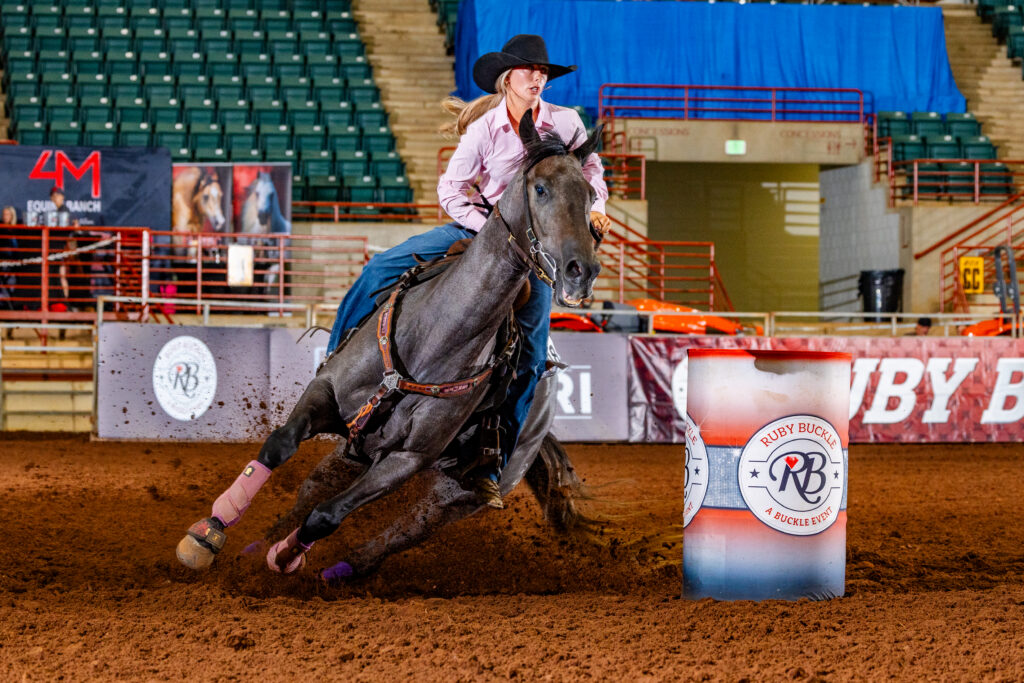Jordan Harrell turns a barrel on a roan horse