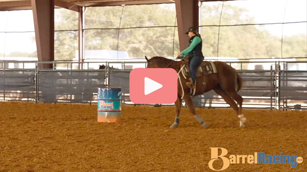 Video thumbnail of a rider in a teal shirt and vest working a sorrel horse around a barrel in a covered arena