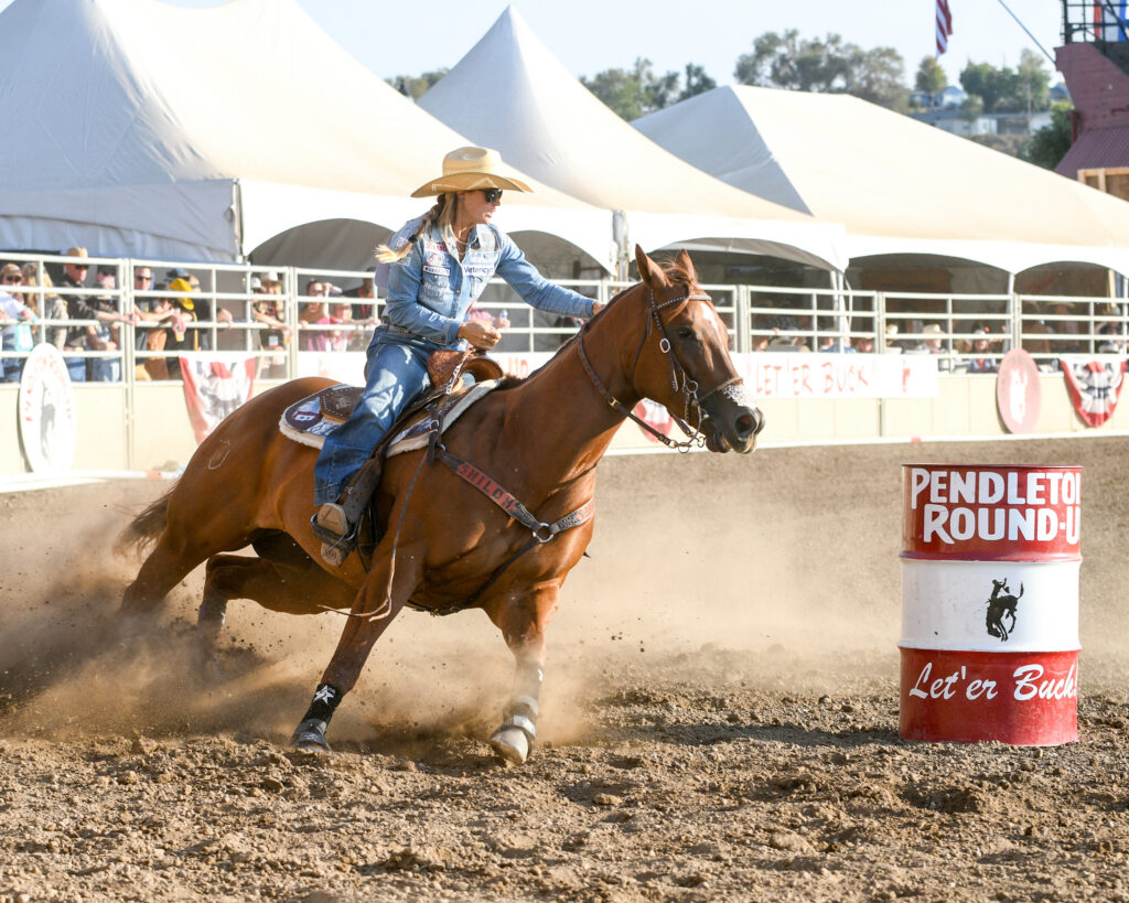 Stevi Hillman turns a barrel on her sorrel horse at Pendleton