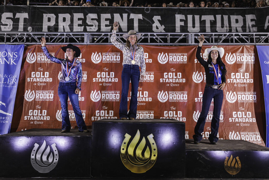 KariAnn Cross, Hayle Stillwell and Mckenna Coronado wave from the podium