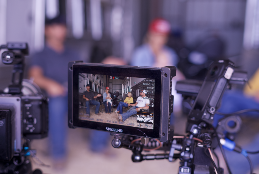 Blurred people shown through a camera screen