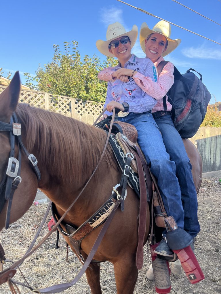 Sarah and Martha Angelone smile horseback