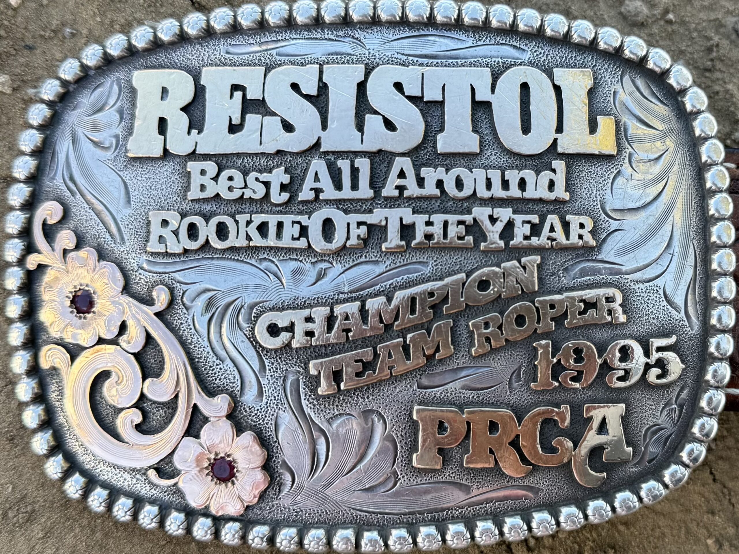 Best All Around Rookie of the Year belt buckle from the 1995 PRCA Champion Team Roper award, featuring ornate silver and gold detailing with floral engravings