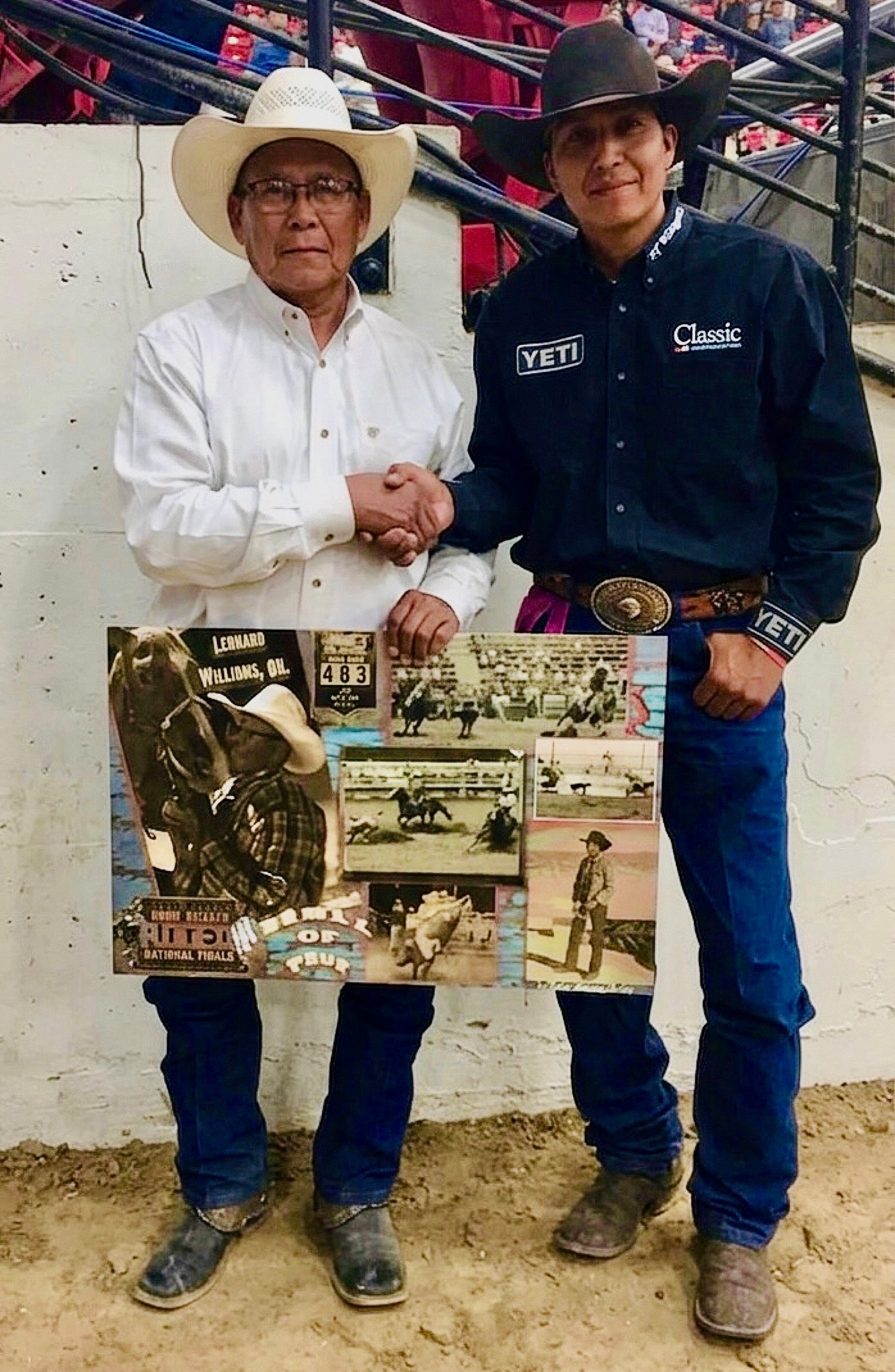 Two men in cowboy hats shake hands at a rodeo arena while holding a collage of vintage rodeo photos honoring Leonard Williams