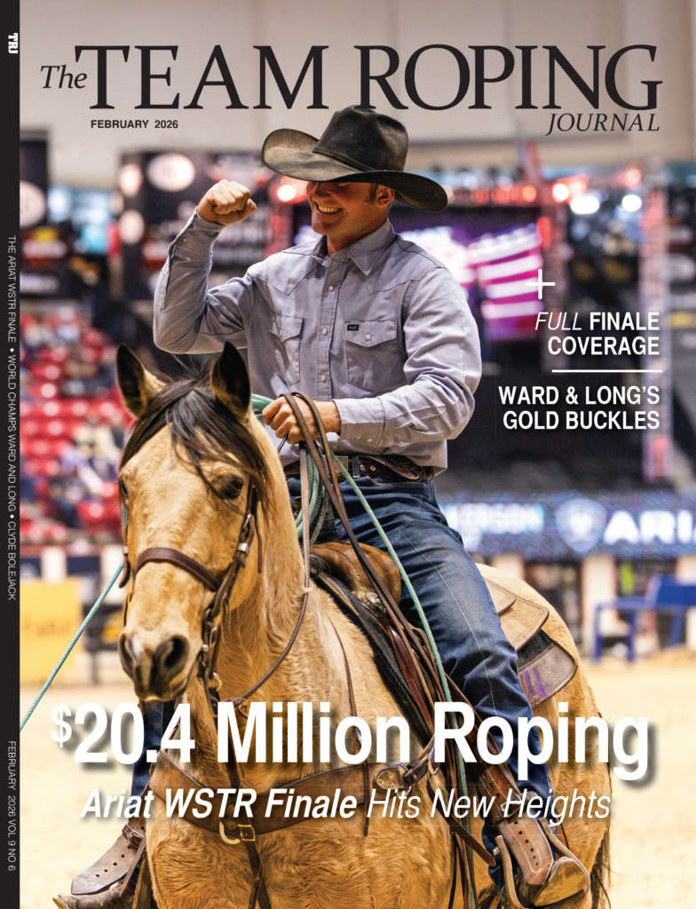 Team roper on palomino horse celebrates with fist pump at rodeo arena during WSTR Finale