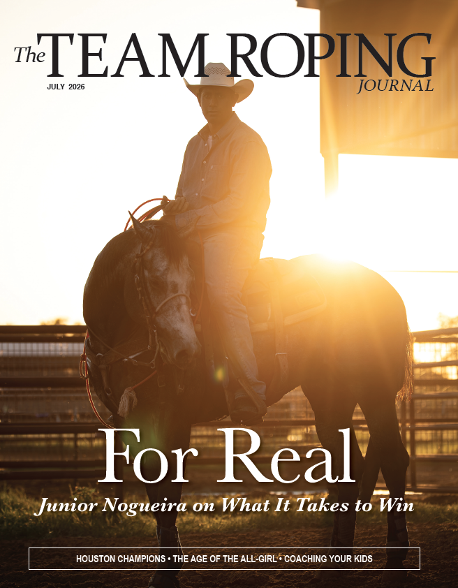 Cowboy on horseback silhouetted against golden sunset, cover of The Team Roping Journal, July 2026