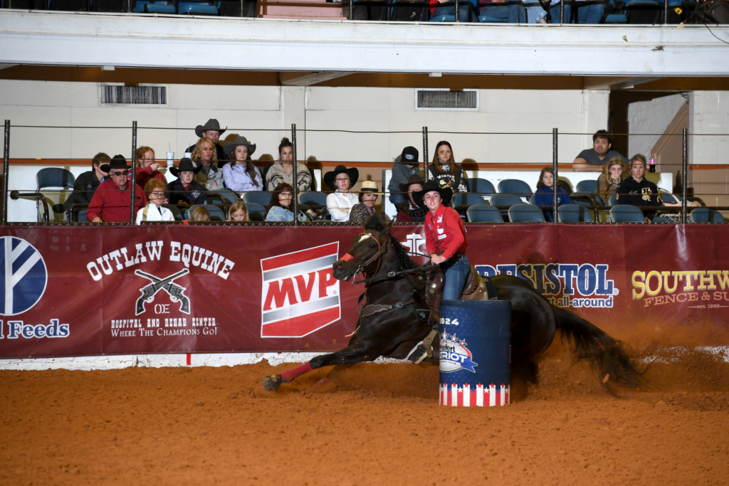 Tana Trosper turning Shiney Cartel around a barrel at the Hooey Junior Patriot.