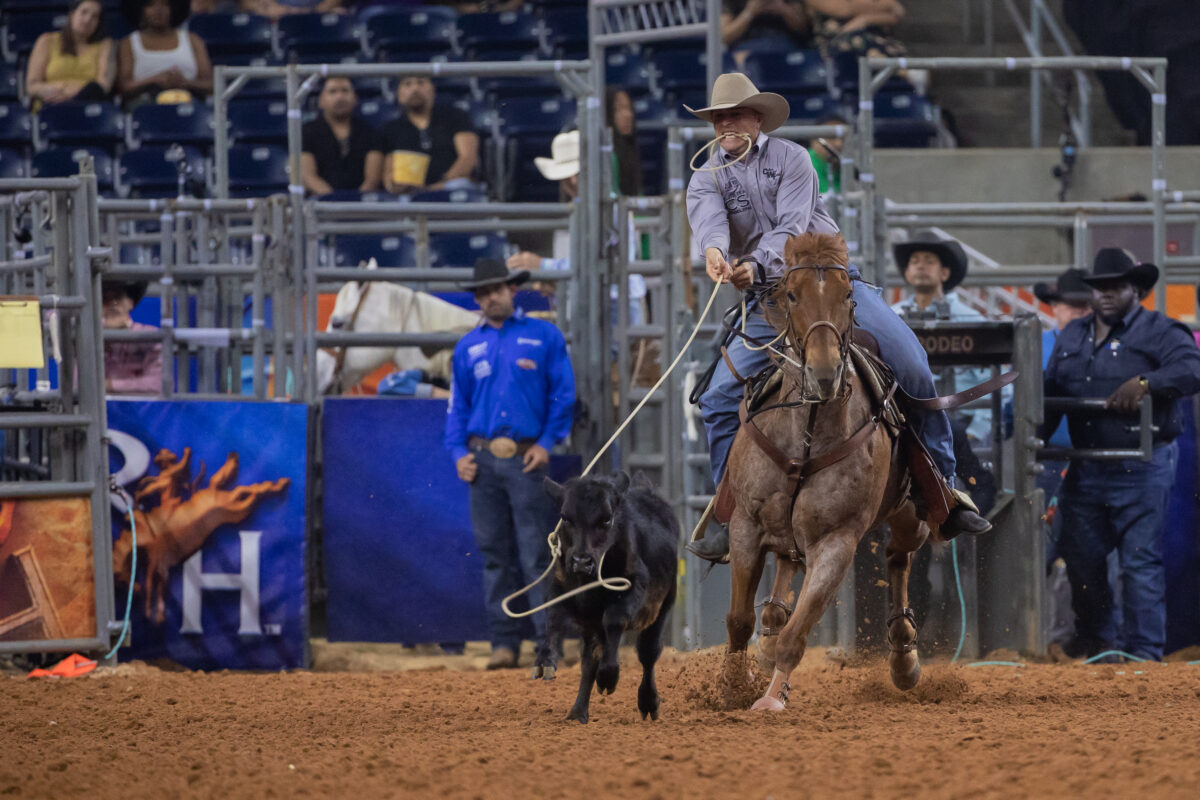 Bo Pickett steps off his horse in the tie-down roping at Houston