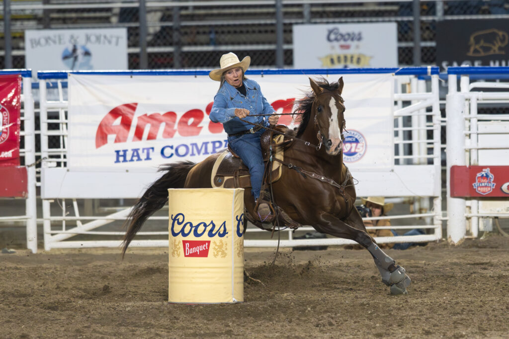 Lanita Peirce rounds a barrel on Famous Wahini