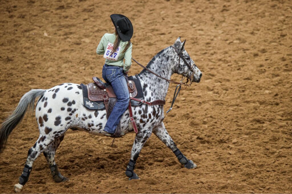 McKenna Hickston and "Spot" lope out of the arena at the 2024 San Antonio Stock Show & Rodeo.