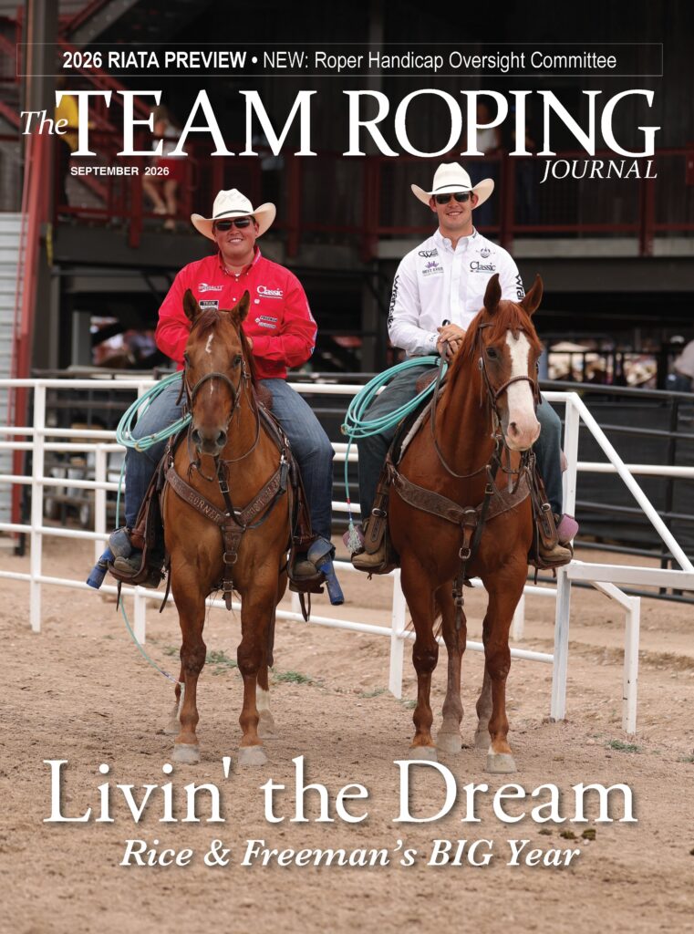 Two team ropers on horseback in an arena, featured on The Team Roping Journal September 2026 cover