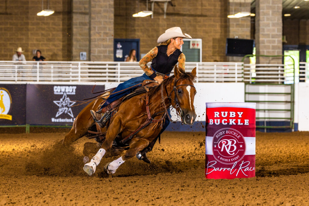 Brielle Scott turns a barrel in a cool black shirt with clear sleeves