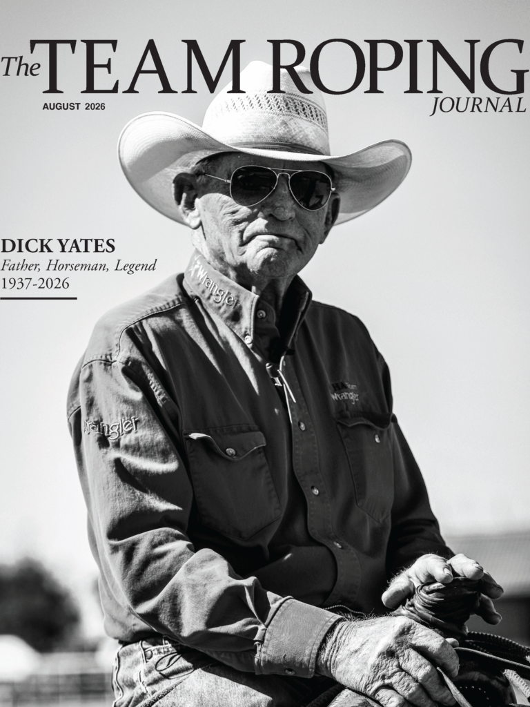 Dick Yates, legendary horseman and father, in cowboy hat and sunglasses holding reins, The Team Roping Journal August 2026 cover