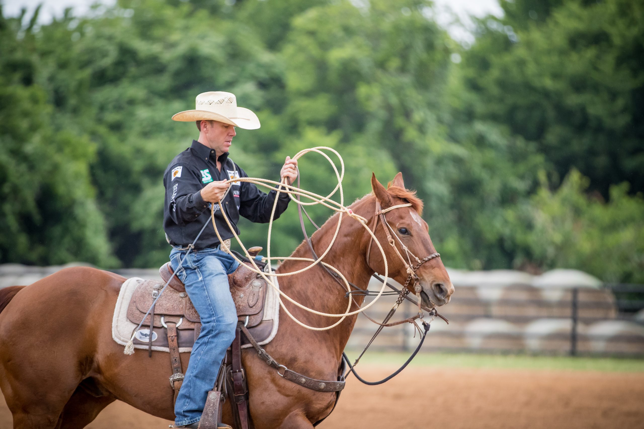 Man with calf rope on horse