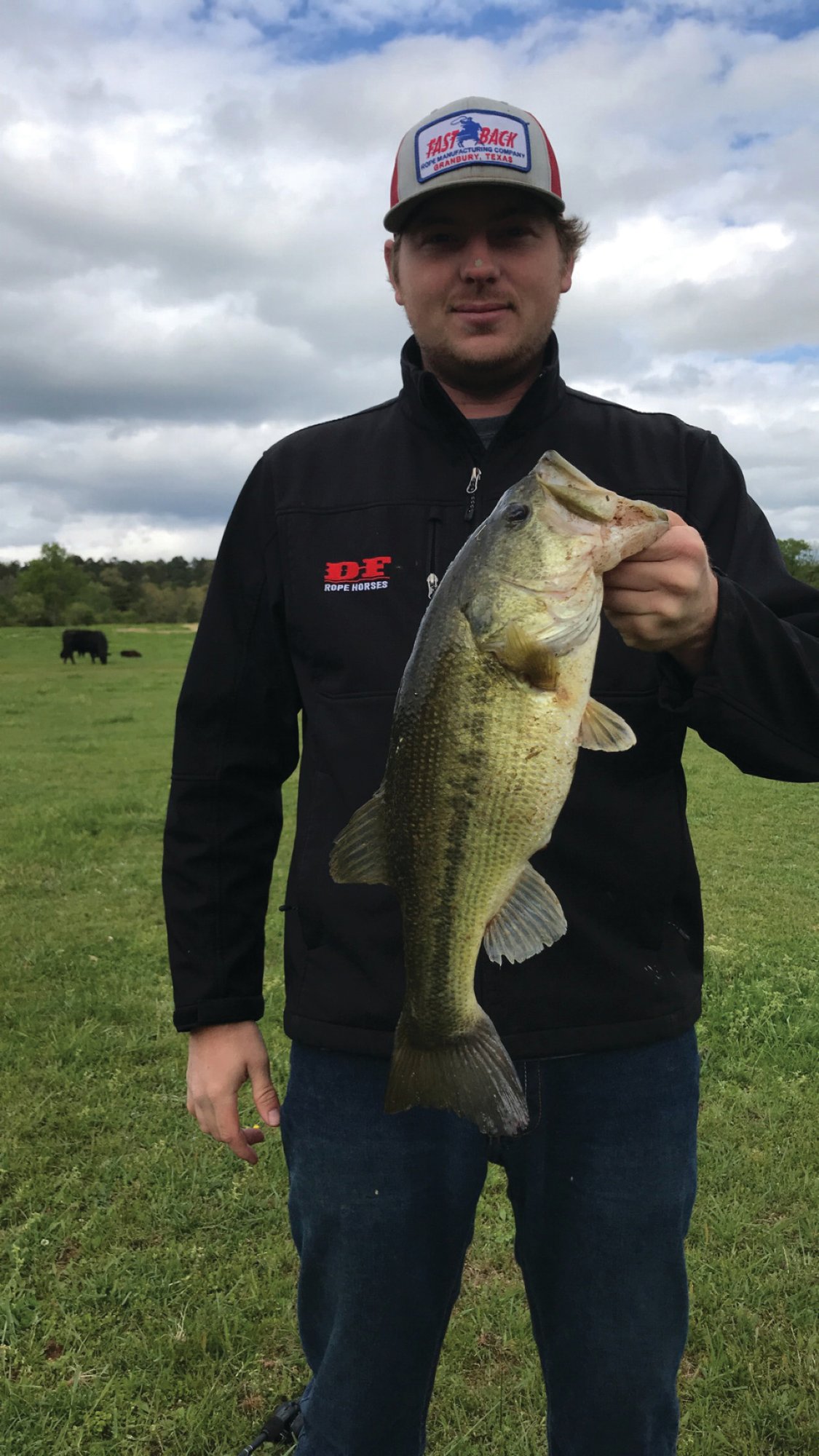 Trent Vaught holding a fish he caught while off the rodeo trail